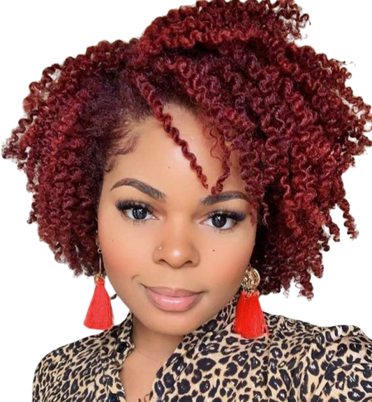 Yoyo Crown short curly red wig with small tight curls worn by a woman with a leopard print top and red tassel earrings