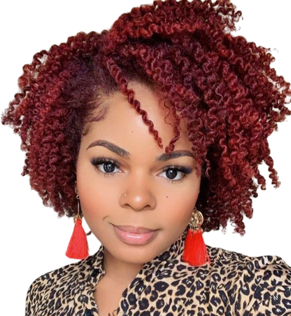 Yoyo Crown short curly red wig with small tight curls worn by a woman with a leopard print top and red tassel earrings